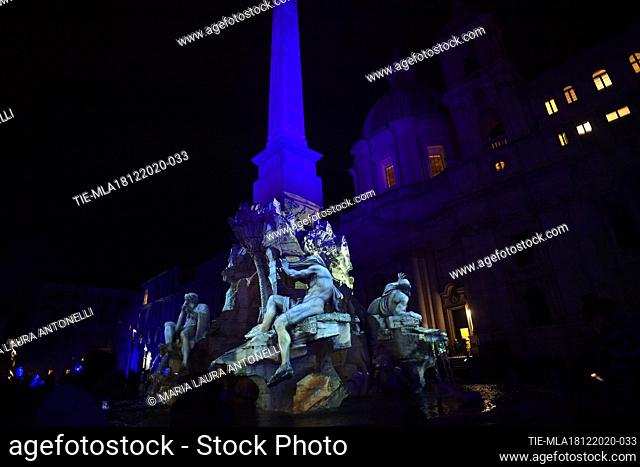 The Fontana dei quattro fiumi (Fountain of the four rivers) in Piazza Navona illuminated with light shows each night for the duration of the Christmas season
