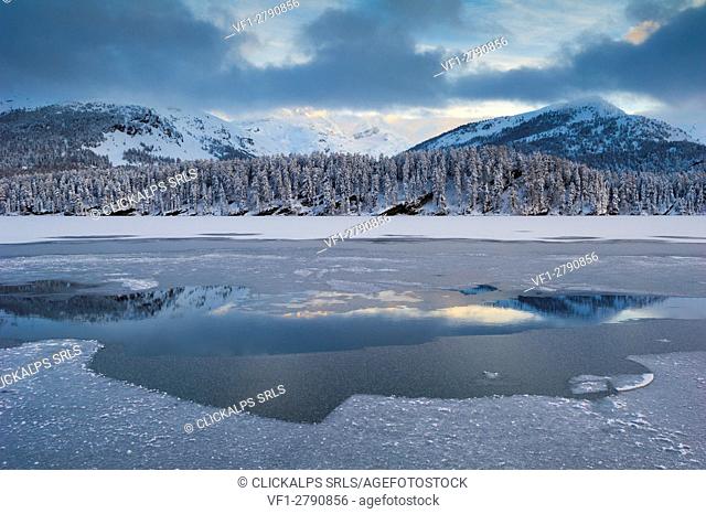 Frozen alpine lake in winter. Engadine, Switzerland