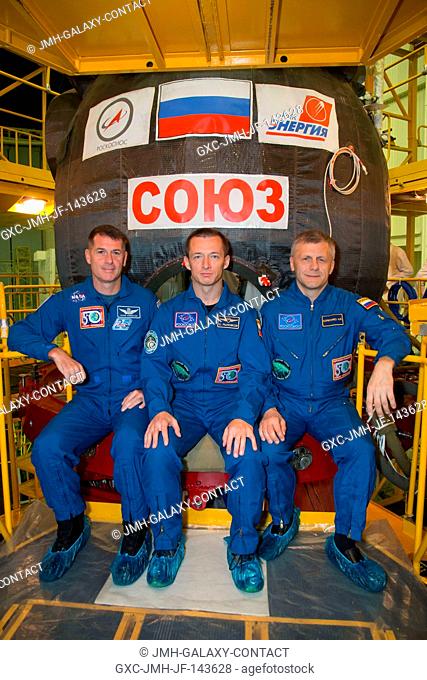 At the Integration Facility at the Baikonur Cosmodrome in Kazakhstan, Expedition 49 crewmembers Shane Kimbrough of NASA (left) and Sergey Ryzhikov (center) and...