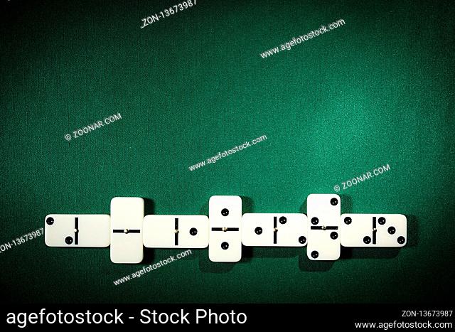 Stacks of Dominoes on a table covered with green cloth