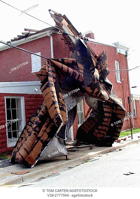 piece of a building wrapped around another building following a tornado
