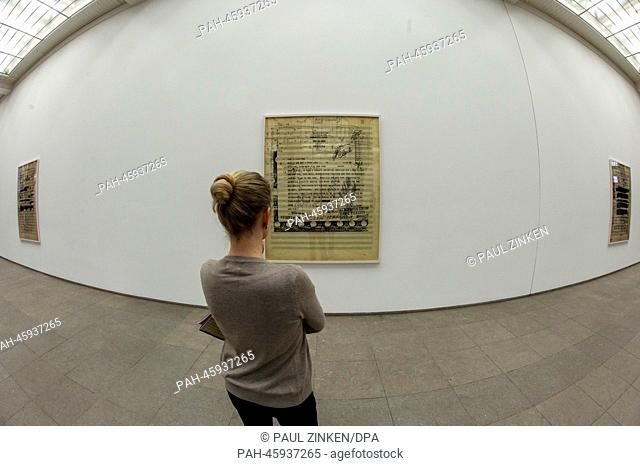 A woman stands at an over-sized sheet of music by composer Hanns Eisler at Hamburger Bahnhof in Berlin,  Germany, 31 January 2014