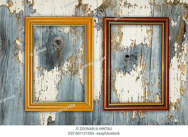 Gold frame on a old wooden wall background