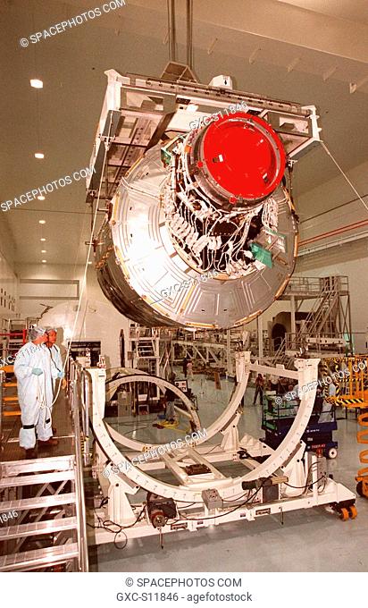 10/10/1998 --- Workers in the Space Station Processing Facility SSPF oversee the lifting of the Unity connecting module, part of the International Space Station