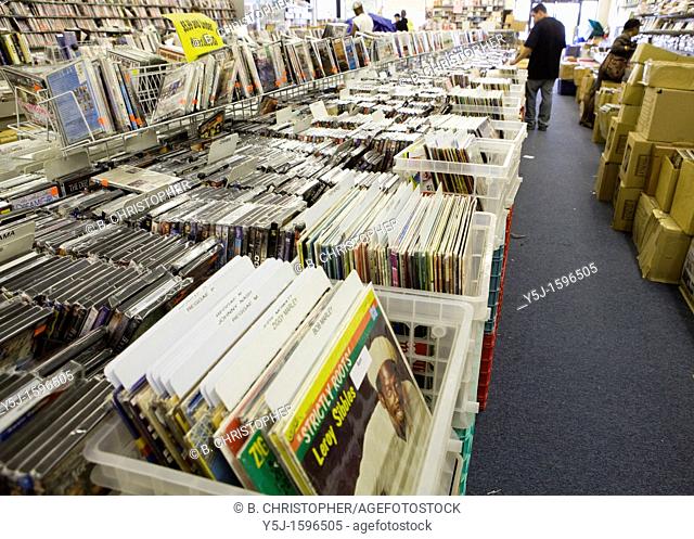 A customer looks through used vinyl records from the past in a record store