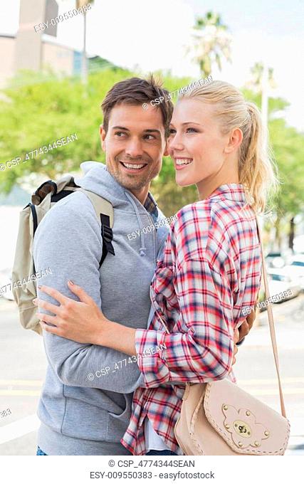 Young tourist couple hugging each other
