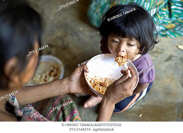 Maya children is fed in Aqua Escondida, Solola, Guatemala
