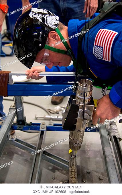 NASA astronaut Reid Wiseman, Expedition 4041 flight engineer, participates in an extravehicular activity (EVA) training session in the Partial Gravity Simulator...