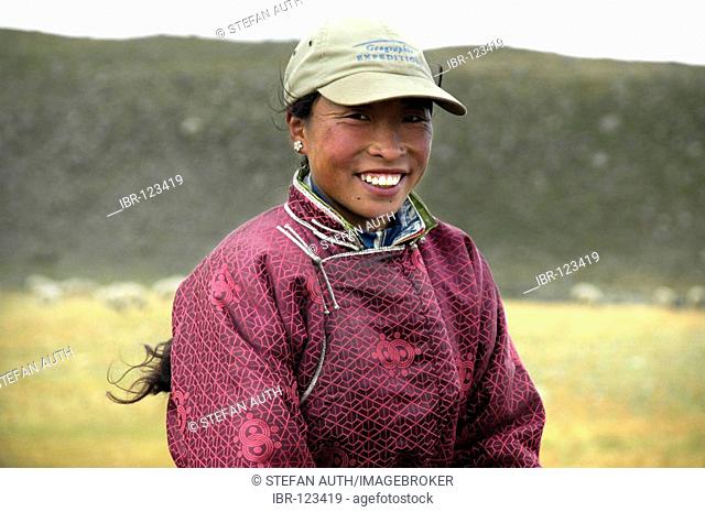 Portrait nomads smiling young woman dressed in traditional coat in the steppe Kharkhiraa Mongolian Altai near Ulaangom Uvs Aymag Mongolia