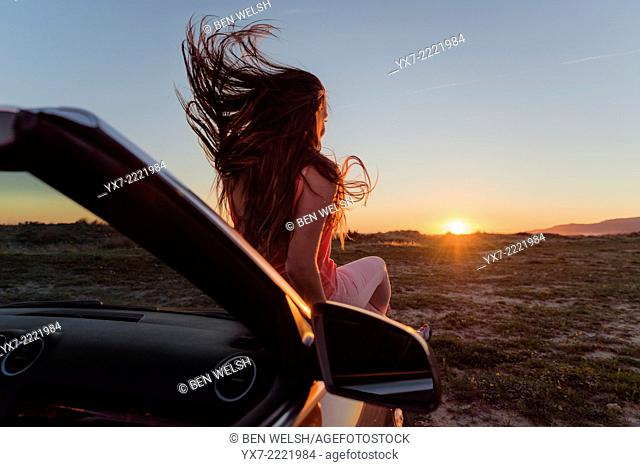 Young woman in a convertible car. Tarifa, Cadiz, Andalusia, Spain, Europe