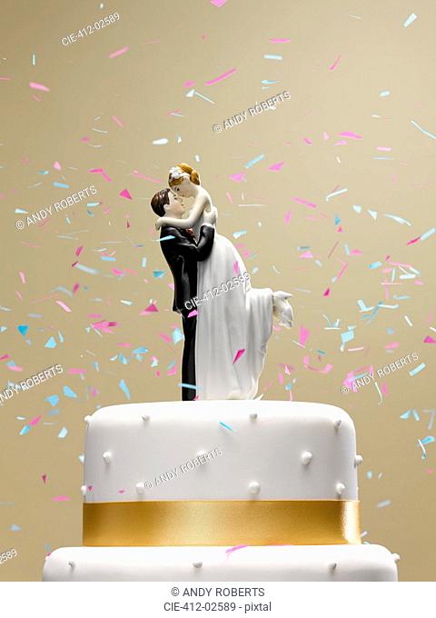 Confetti falling on wedding cake