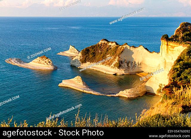 Cliffs at cape Akra Drastis in the island of Corfu in Greece, bathed in afternoon light