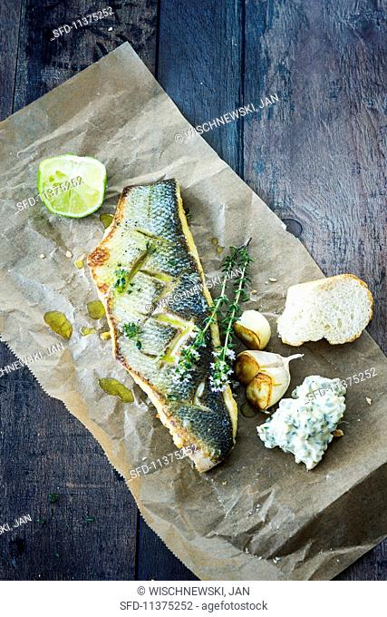 Grilled sea bass with roulade and thyme flowers