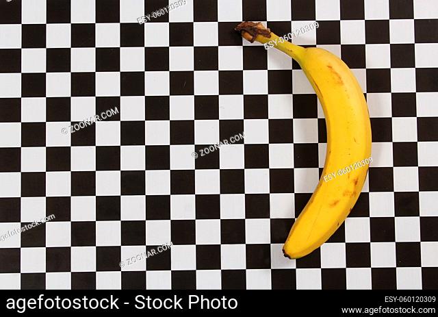 Ripe Banana on Black and White Checkered Table