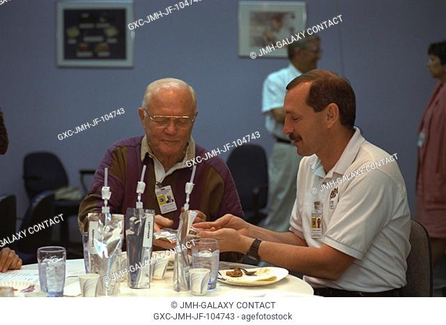 Two members of the STS-95 crew participate in a food tasting session at the Johnson Space Center (JSC). Pictured are U.S. Sen. John H. Glenn Jr