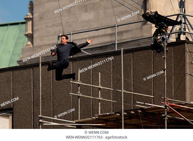 Tom Cruise leaps from the roof of one building to another while filming the next film in the 'Mission: Impossible' series; Cruise appeared to injure himself in...