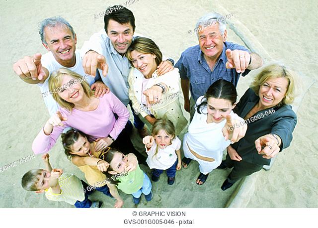 High angle view of family pointing at camera