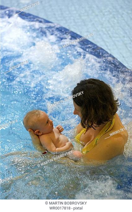 mother with baby in swimming bath