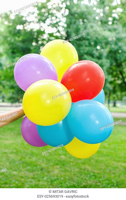 Female Hands Hold Colorful Balloons Outdoor