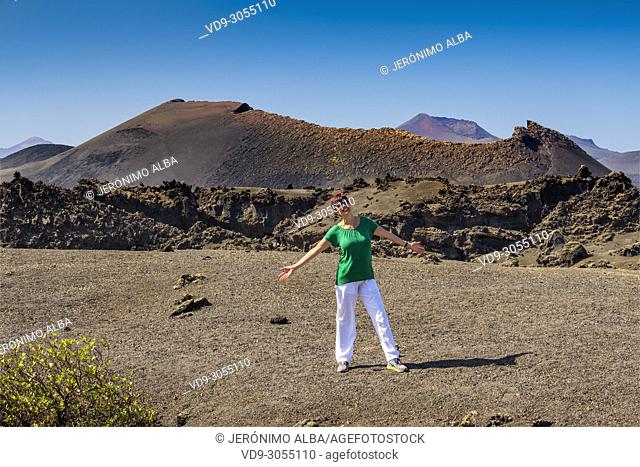 Tourist woman. Volcanic landscape, Timanfaya National Park. Lanzarote Island. Canary Islands Spain. Europe