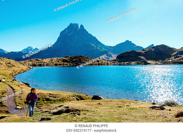 a woman hiker walking in the Pyrenees mountains near the Pic Ossau