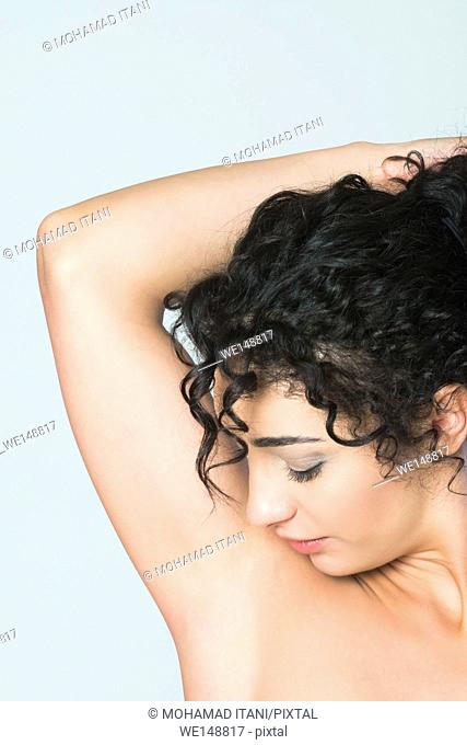 Close up of a young woman looking at shaved armpits