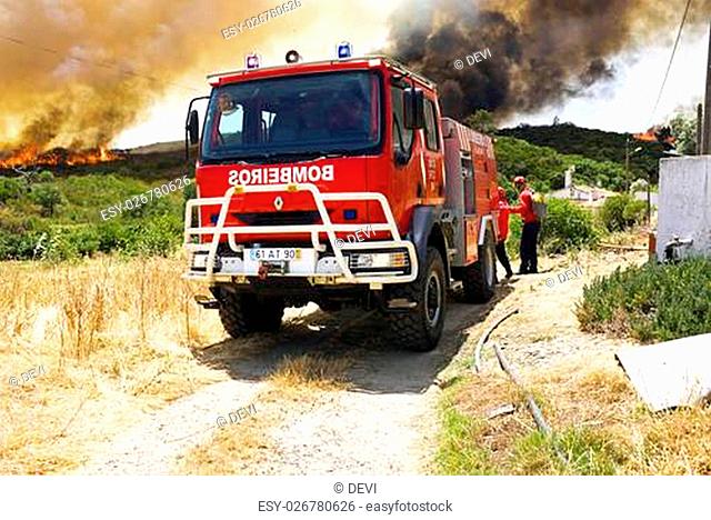 ALJEZUR - JULY 6: Firefighters fighting a huge bushfire in the national park near Aljezur on 6th july 2013 in Portugal