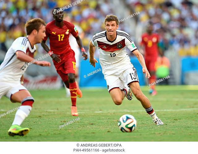 Germany's Thomas Mueller (R) and Ghana's Mohammed Rabiu vie for the ball during the FIFA World Cup 2014 group G preliminary round match between Germany and...