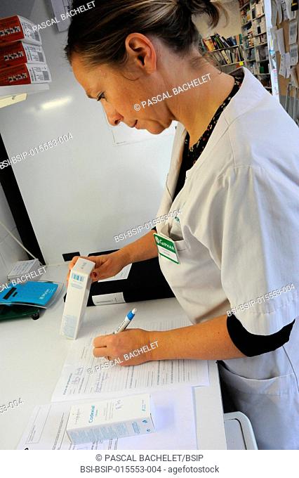 Reportage in a pharmacy in Auxi-le-Château, France. A pharmacy technician prepares a glycerol starch-based treatment. Preparation sheet