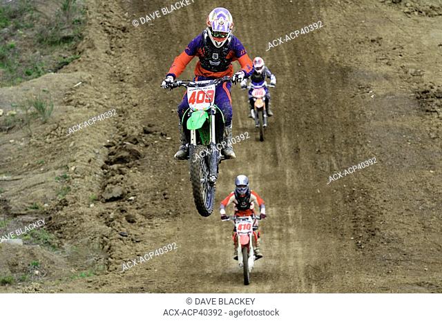 Motocross rider 409 gets airborne during a jump as he tries to stay ahead of his fellow racers at the Wastelands track in Nanaimo, British Columbia, Canada