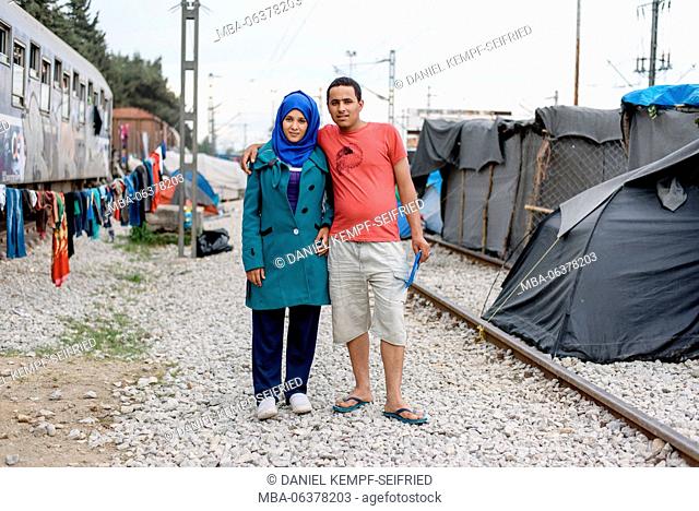 A young couple from Syria. pregnant woman and husband searching for a doctor. refugee camp in Idomeni in Greece at the frontier to Macedonia, April, 2016