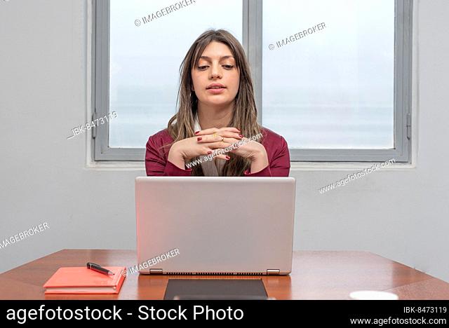 Woman concentrated on her work while she is looking at her laptop
