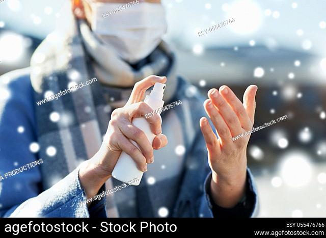 close up of woman spraying hand sanitizer