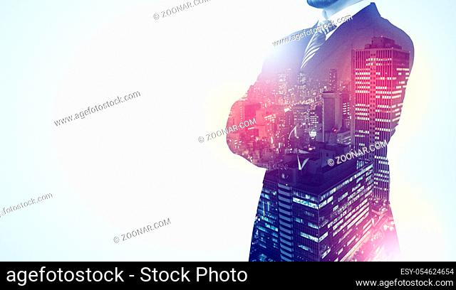 Young businessman standing and thinking with night city background