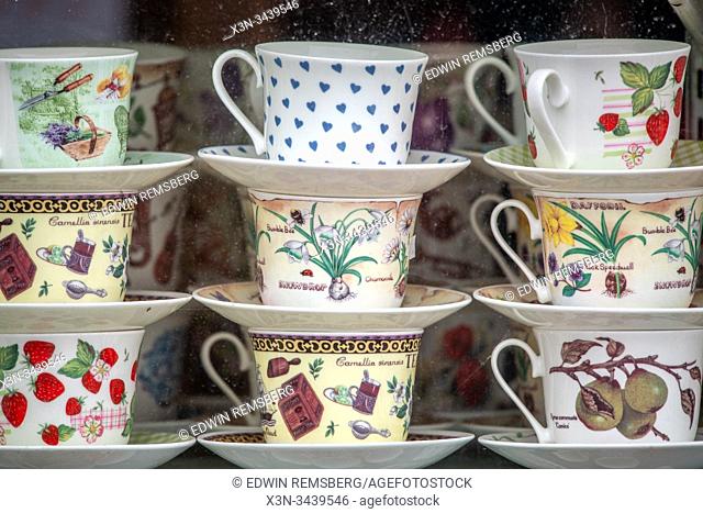 Sets of porcelain tea cups decorated with gardening tools and plants, Whitby, United Kingdom