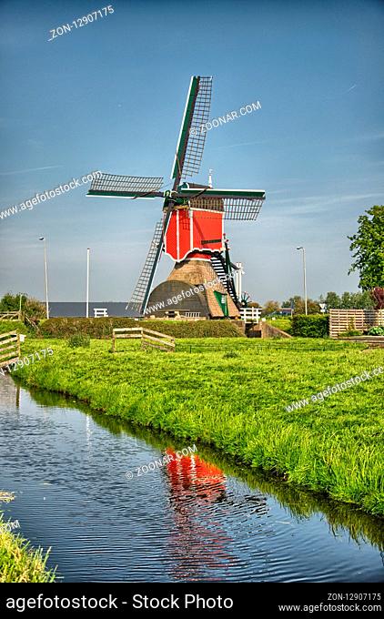 Windmills and water canal in Kinderdijk, Holland or Netherlands. Unesco world heritage site. Europe. HDR
