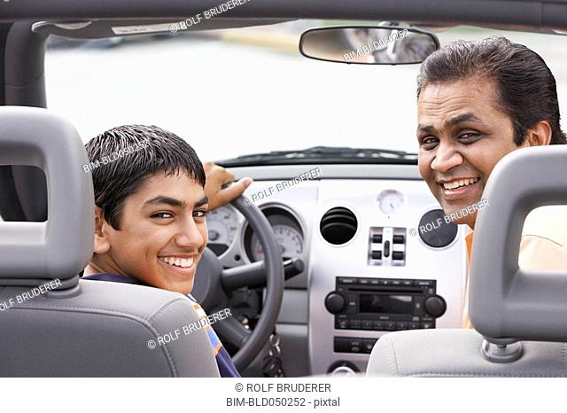 Middle Eastern father and son in new car