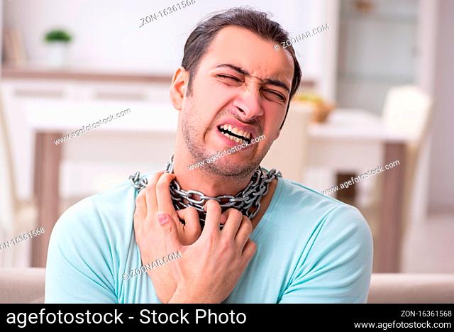Young man suffering from sore throat at home