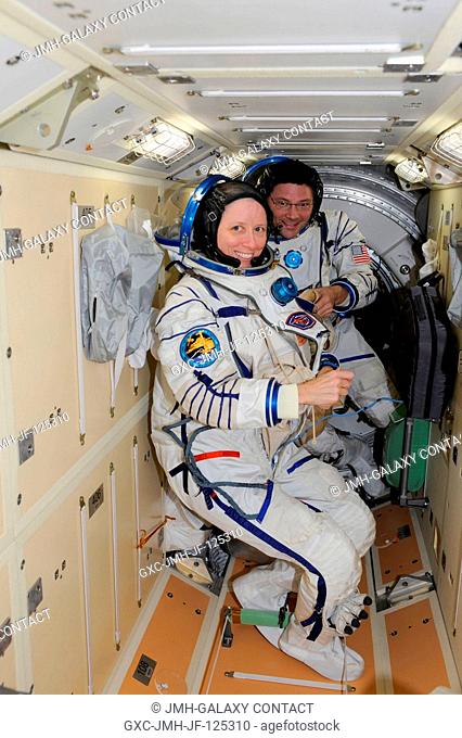 NASA astronauts Shannon Walker, Expedition 25 flight engineer, and Doug Wheelock, Expedition 25 commander; have donned their Sokol (Russian word for 'Falcon')...