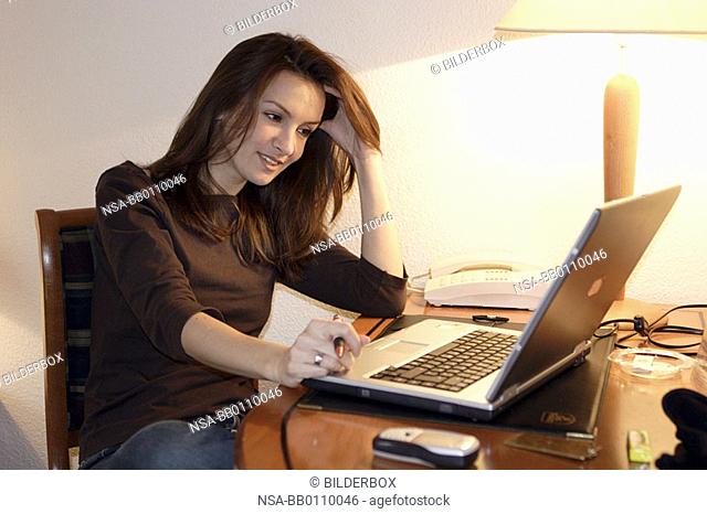 woman with notebook in a hotel room