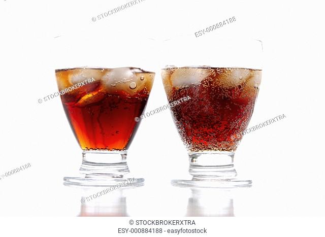Close-up of two glasses of coca-cola on a white background