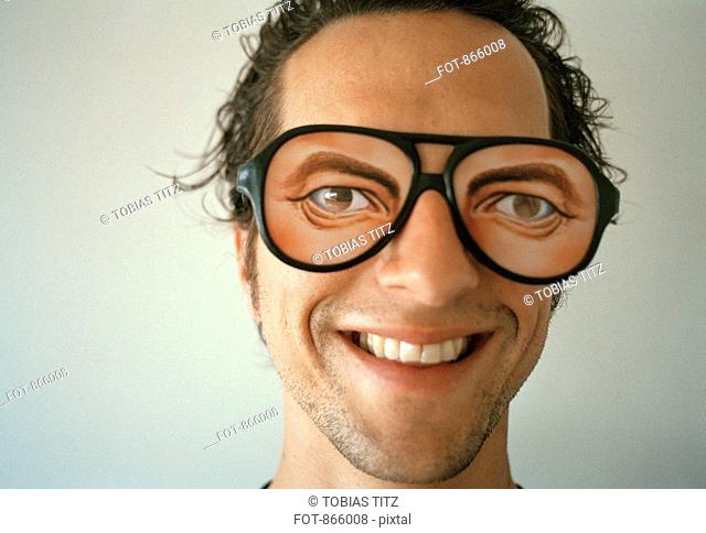 A man wearing novelty glasses and smiling