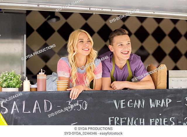 happy young sellers at food truck