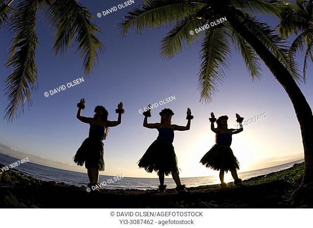 Three hula dancers at sunset at Olowalu, Maui, Hawaii