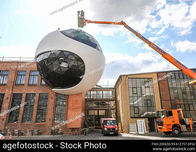 23 June 2020, Saxony, Leipzig: Window cleaners clean the windows of the ""Niemeyer Sphere"" on the premises of the traditional crane manufacturer Kirow