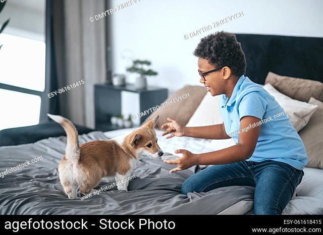 Playing with dog. A boy having fun with his dog and looking excited