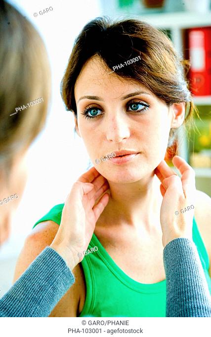 General practitioner palpating the lymphatic glands of a patient during medical consultation