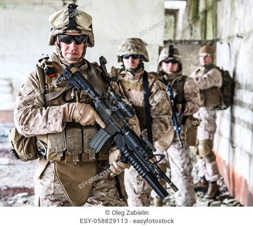 Squad of US marines in ruined building
