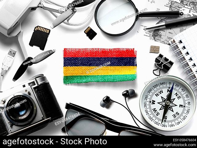Flag of Mauritius and travel accessories on a white background. The view from the top