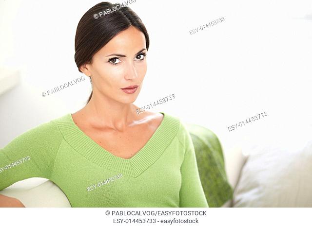 Beautiful woman with confidence and with caucasian ethnicity looking at the camera at indoors - copy space